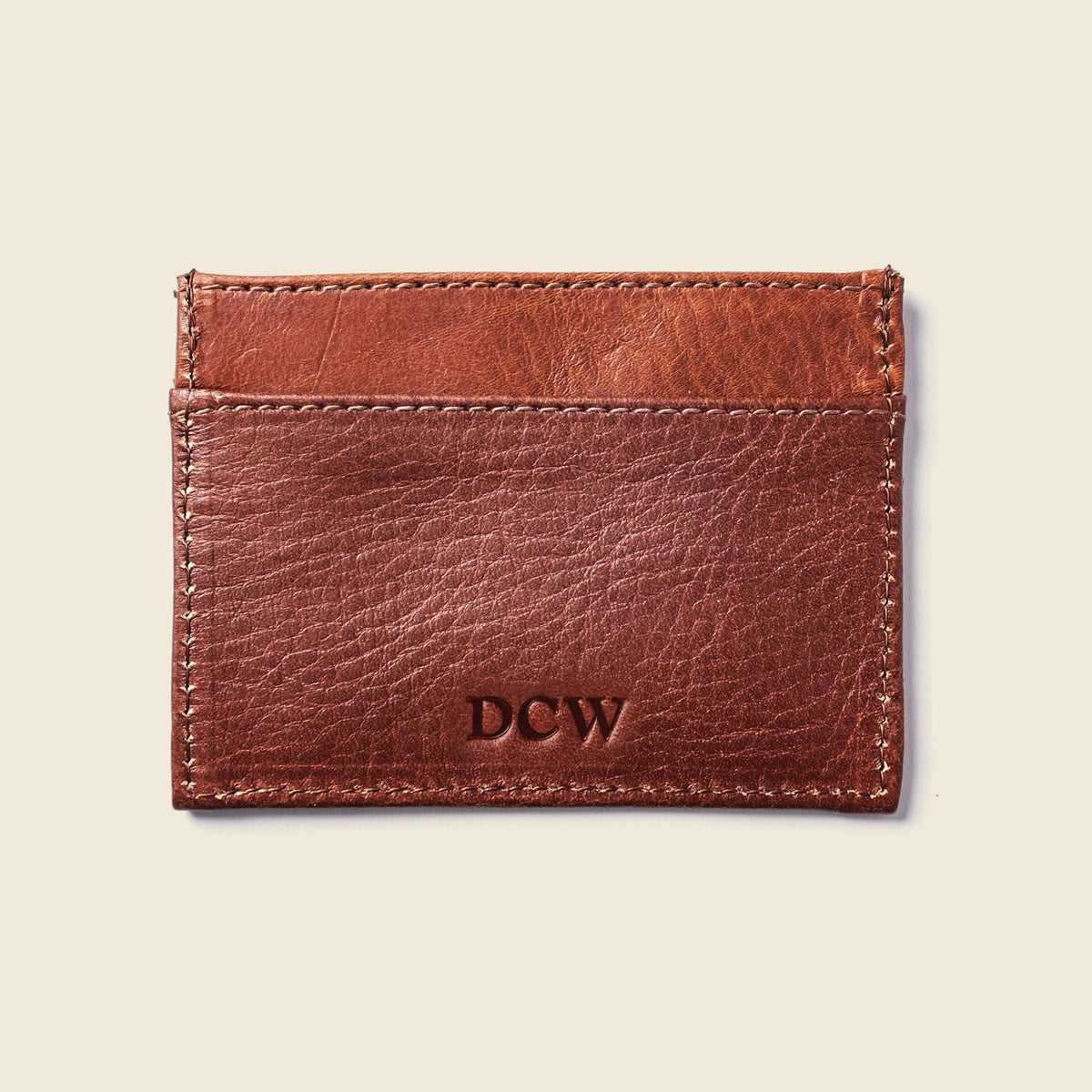 CASUPO slim card holder in chocolate brown leather, back view with embossed monogram