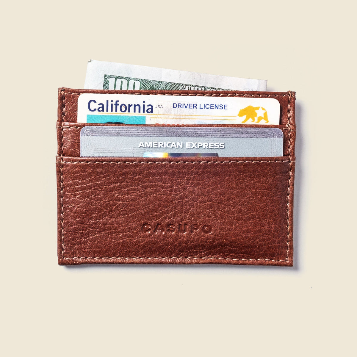 CASUPO slim card holder in chocolate brown leather, front view holding cards
